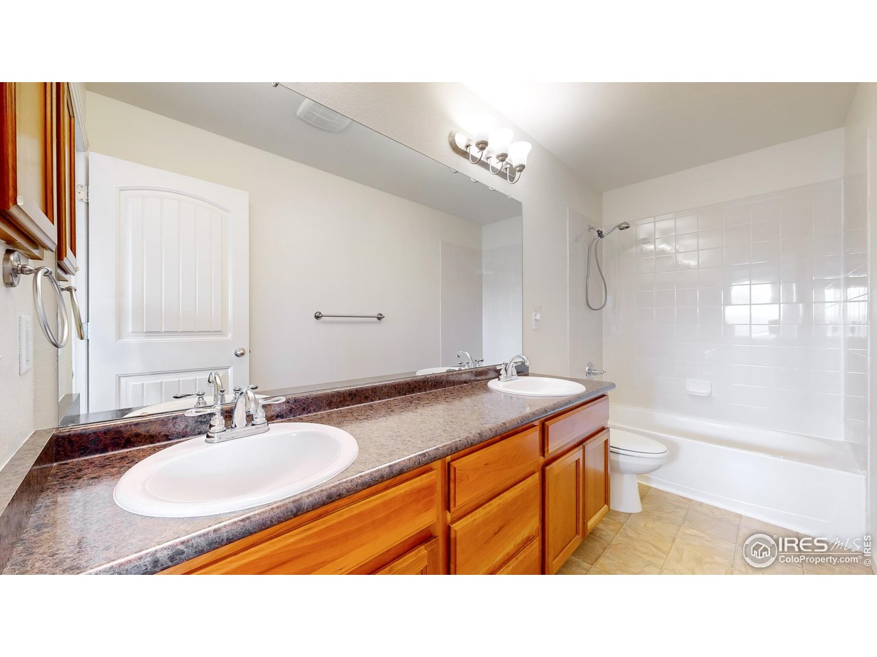 419 Clark Street Johnstown, CO 80534 - Photo 16 of 31 a bathroom with a sink double vanity granite tub shower and a mirror