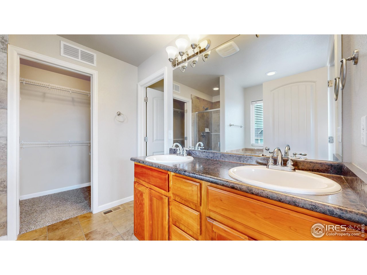 419 Clark Street Johnstown, CO 80534 - Photo 20 of 31 a bathroom with a sink a mirror and a shower