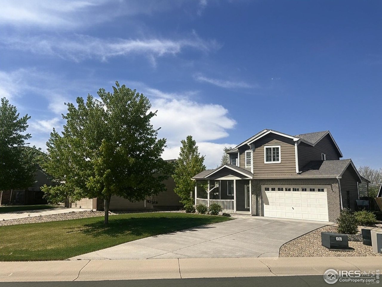 419 Clark Street Johnstown, CO 80534 - Photo 2 of 31 a front view of a house with a garden