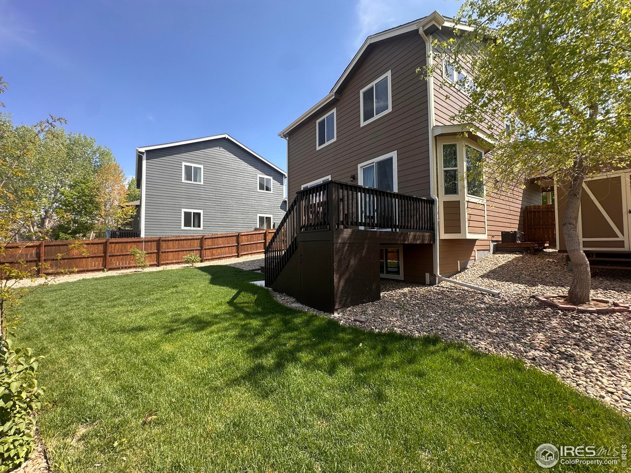 419 Clark Street Johnstown, CO 80534 - Photo 23 of 31 a backyard of a house with barbeque oven and barbeque oven