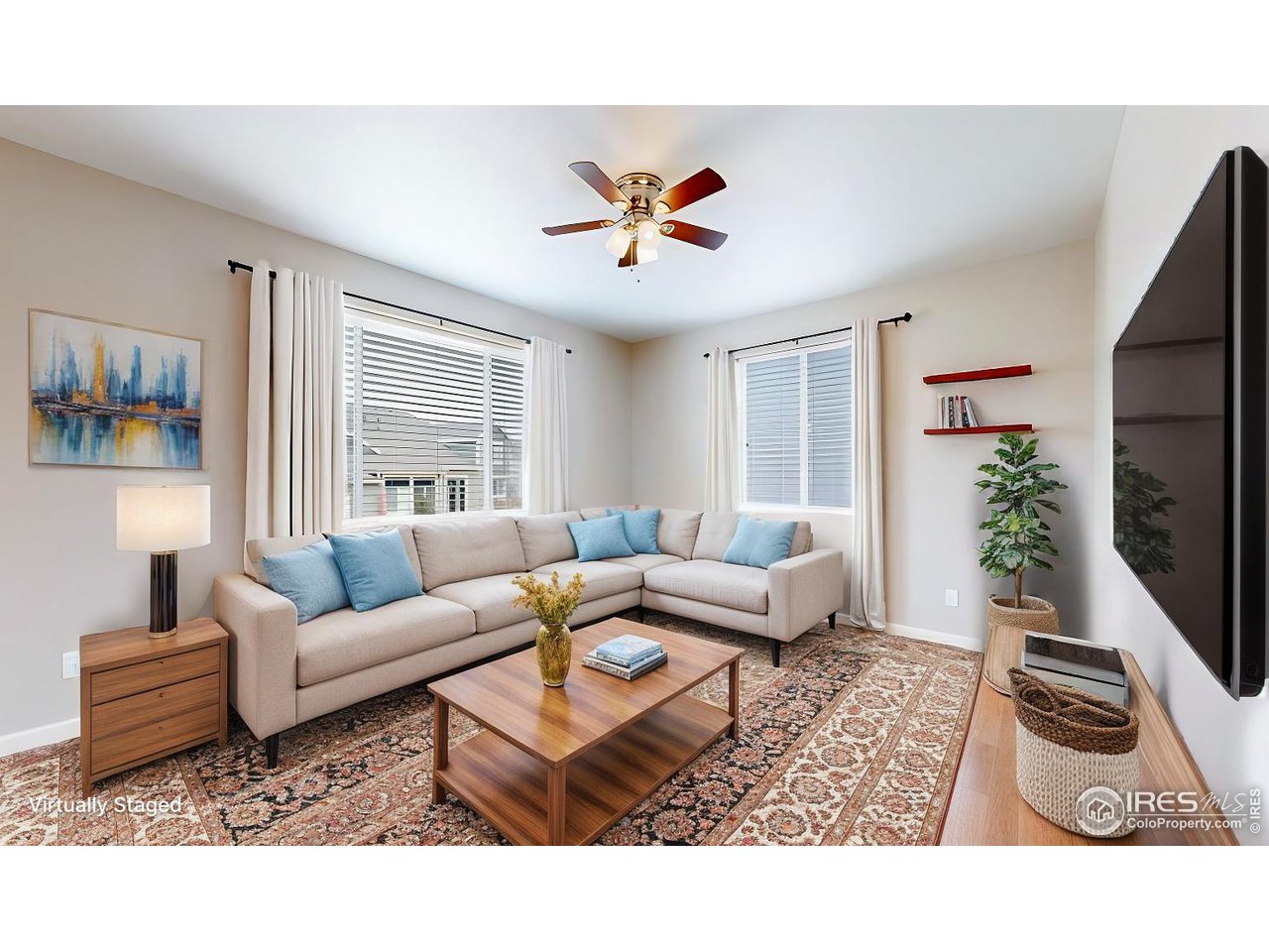 419 Clark Street Johnstown, CO 80534 - Photo 4 of 31 a living room with furniture and a flat screen tv