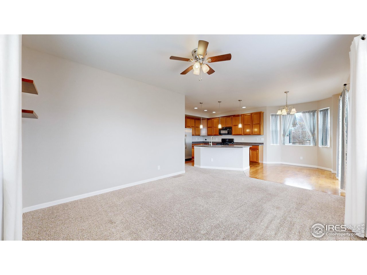 419 Clark Street Johnstown, CO 80534 - Photo 5 of 31 a open kitchen with a sink and a refrigerator