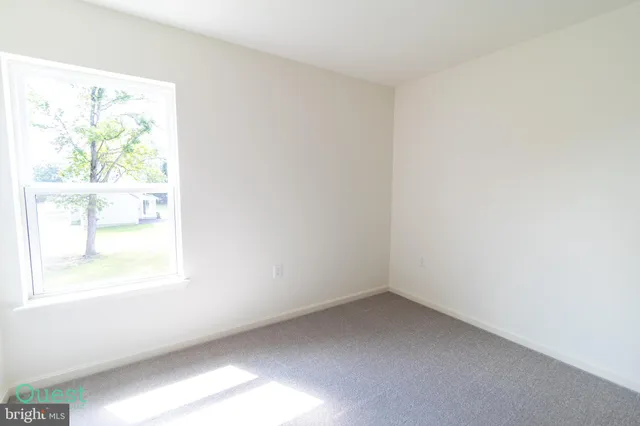 a view of a room with wooden floor and windows