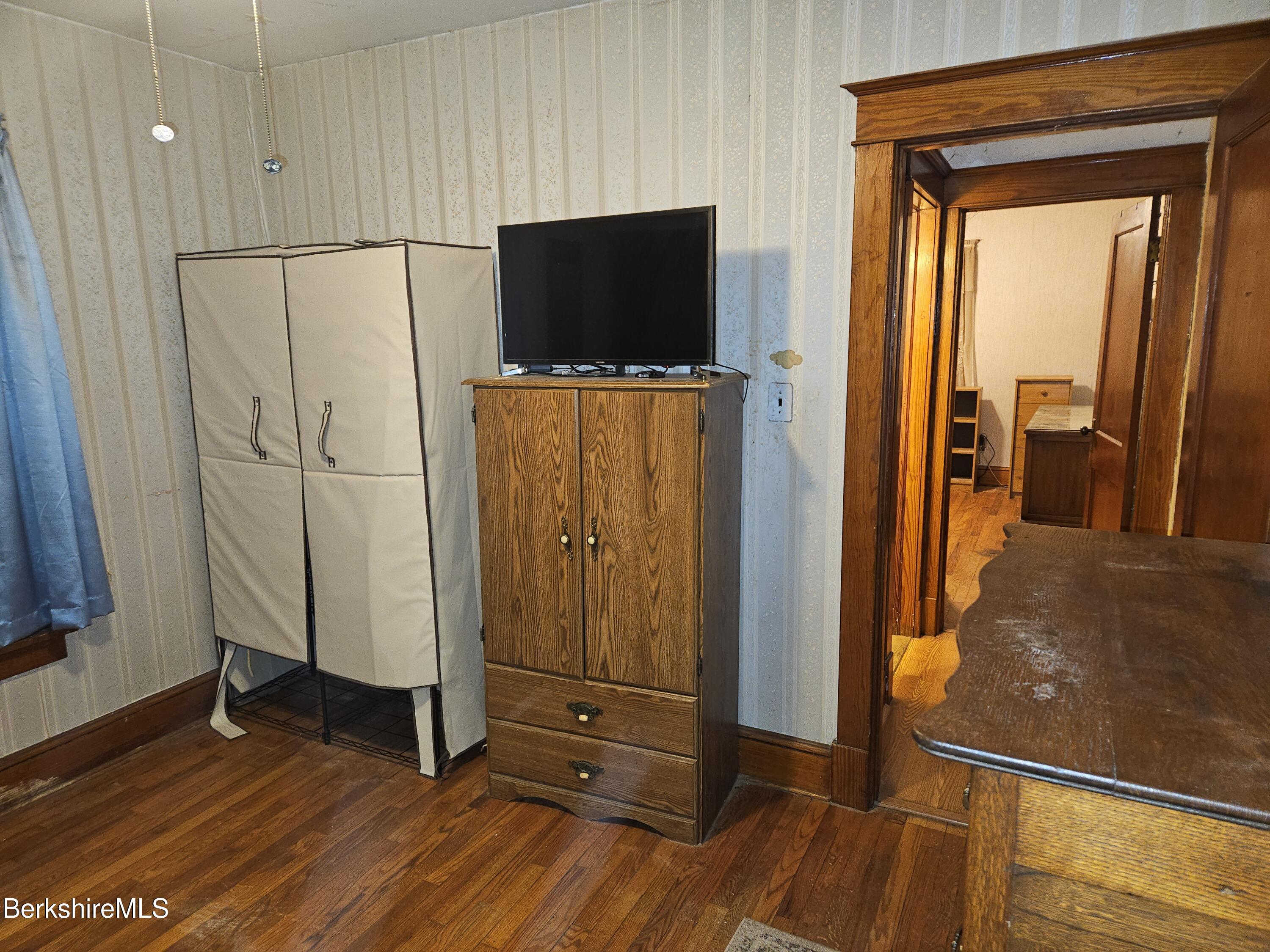 269 2nd Street Pittsfield, MA 01201 - Photo 29 of 39 a view of a livingroom with wooden floor and a flat screen tv