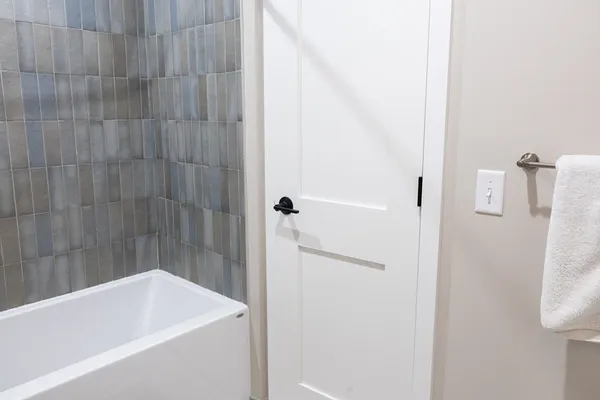 a bathroom with a bathtub and shower