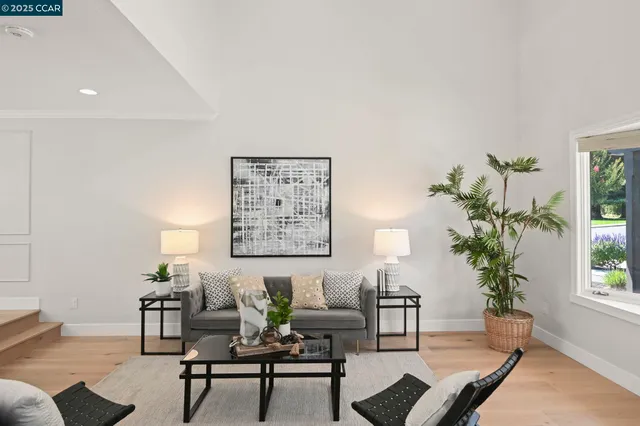 a view of a dining room with furniture wooden floor and a chandelier
