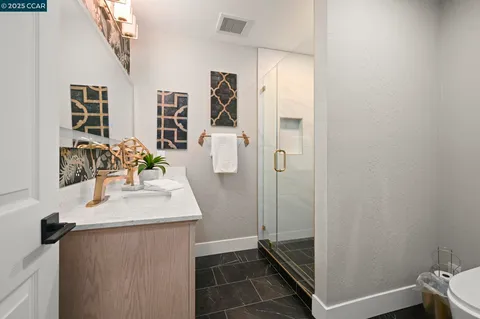 a bathroom with a glass door shower