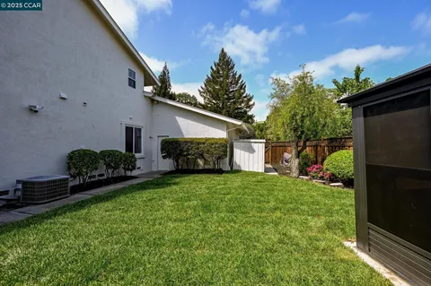 a house view with a sitting space and garden