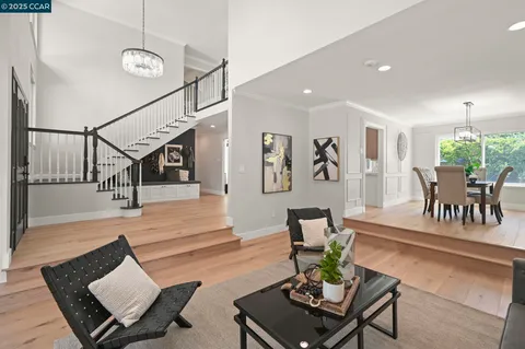 a large white kitchen with a large window and stainless steel appliances