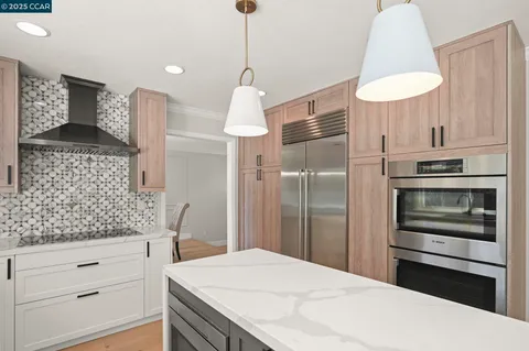 a kitchen with stainless steel appliances a sink stove and cabinets