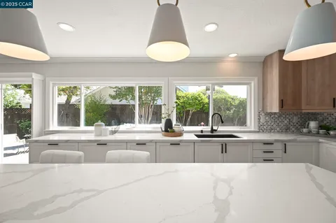 a kitchen with stainless steel appliances a sink stove and refrigerator