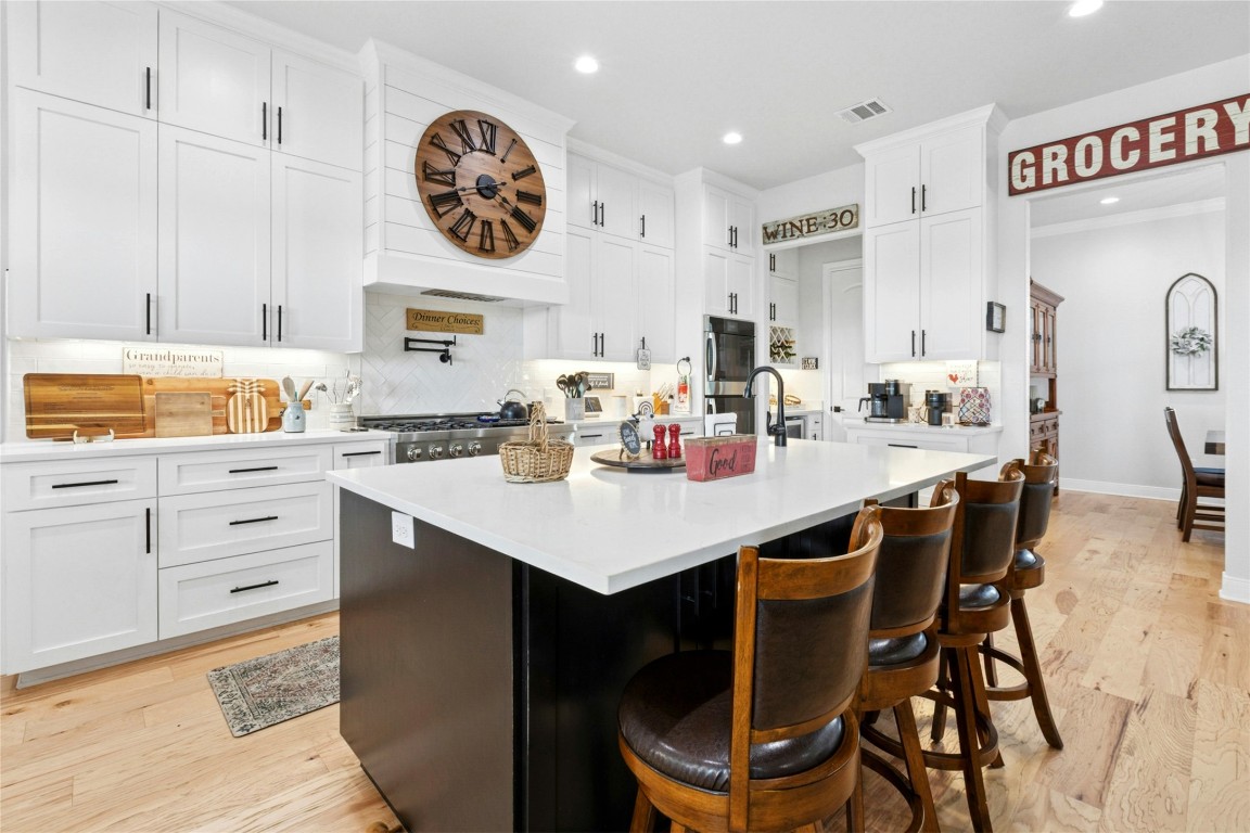 1170 Watterson Road Red Rock, TX 78662 - Photo 13 of 36 a kitchen with a dining table cabinets and a clock