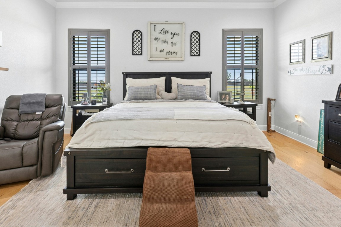 1170 Watterson Road Red Rock, TX 78662 - Photo 16 of 36 a bedroom with a bed and wooden floor