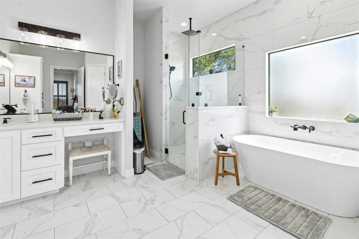 1170 Watterson Road Red Rock, TX 78662 - Photo 19 of 36 a bathroom with a bathtub sink and a mirror