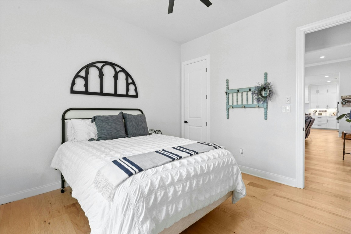 1170 Watterson Road Red Rock, TX 78662 - Photo 20 of 36 a bedroom with a bed and wooden floor