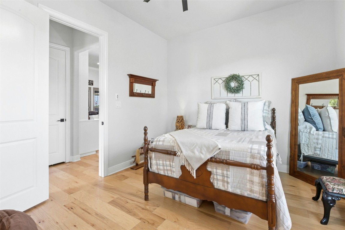1170 Watterson Road Red Rock, TX 78662 - Photo 23 of 36 a bedroom with a bed and a painting on the wall