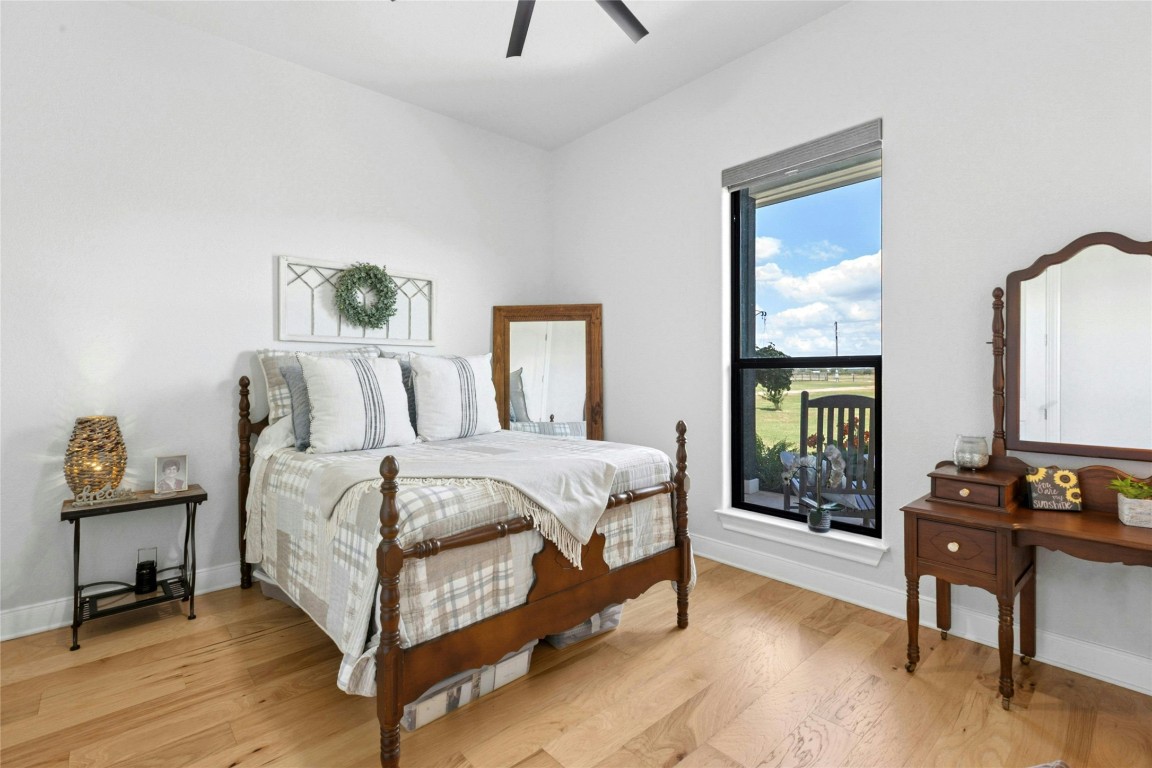 1170 Watterson Road Red Rock, TX 78662 - Photo 24 of 36 a bedroom with a bed a mirror and a window