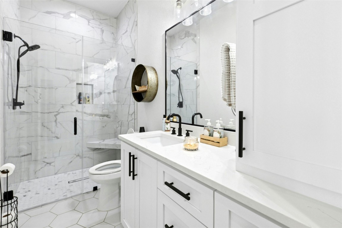1170 Watterson Road Red Rock, TX 78662 - Photo 25 of 36 a bathroom with a sink a toilet and shower