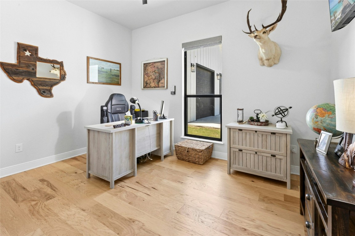 1170 Watterson Road Red Rock, TX 78662 - Photo 28 of 36 a room that has a bed and a wooden floor