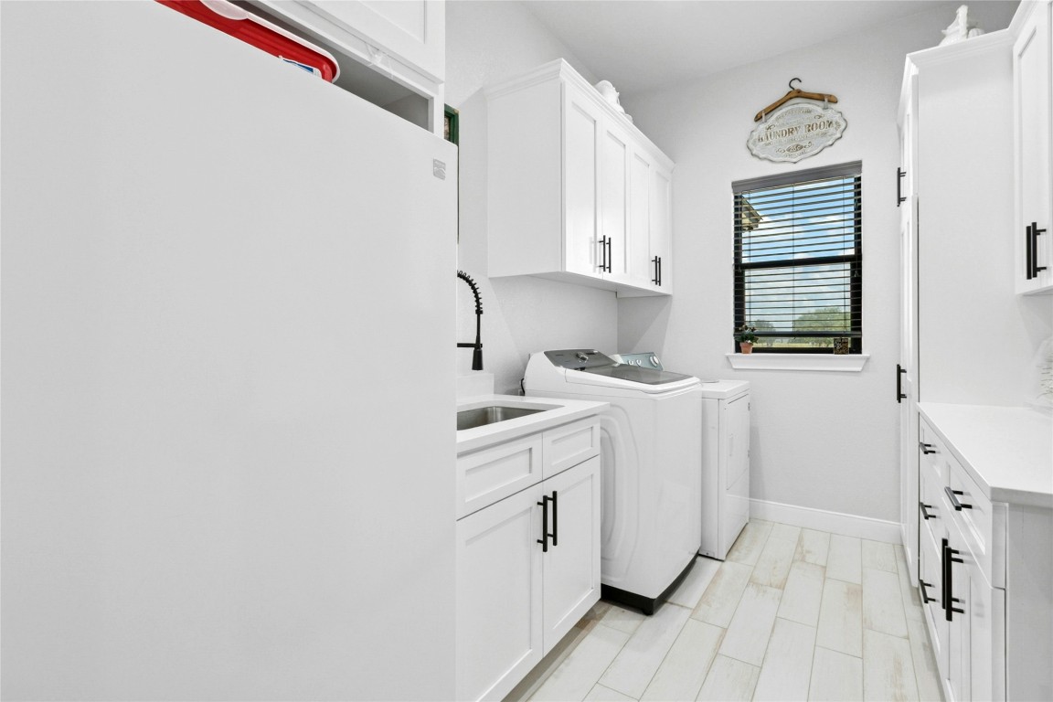1170 Watterson Road Red Rock, TX 78662 - Photo 29 of 36 a utility room with cabinets washer and dryer