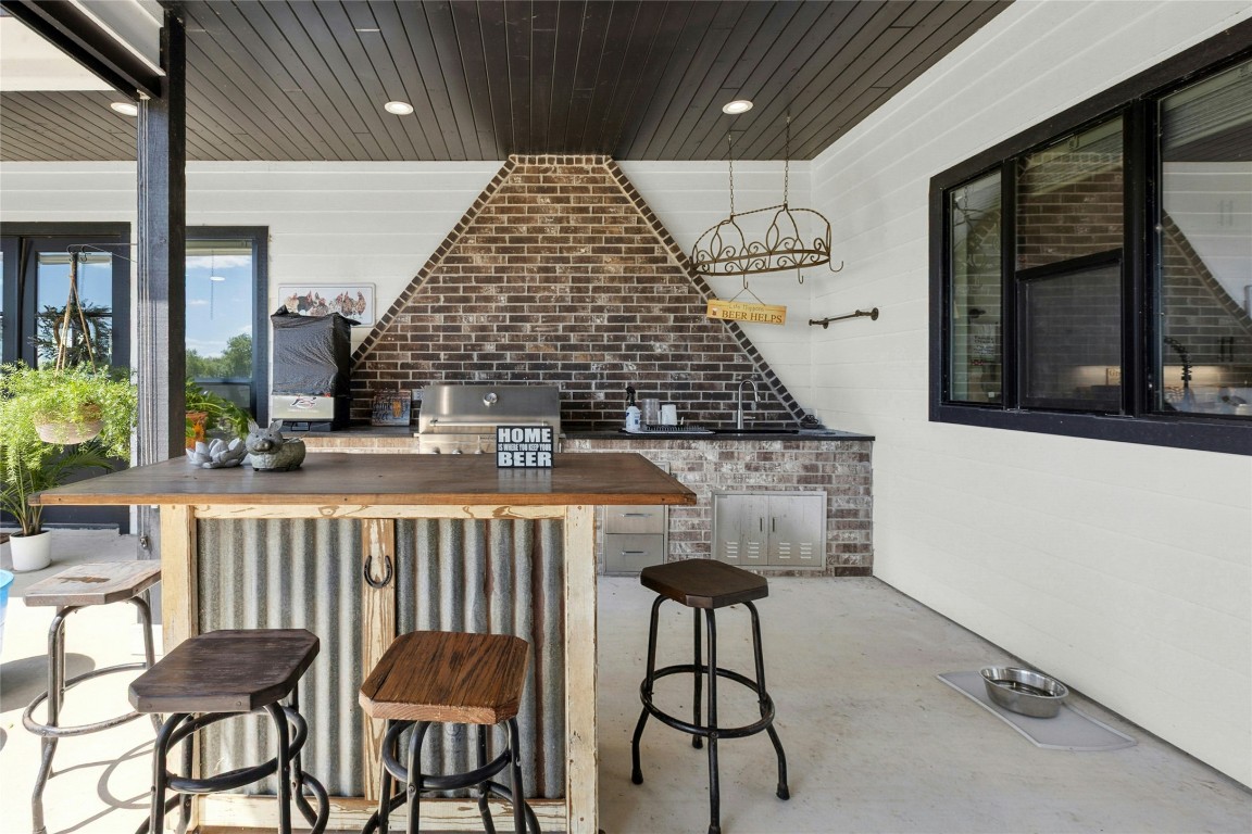 1170 Watterson Road Red Rock, TX 78662 - Photo 30 of 36 a roof deck with table and chairs and potted plants