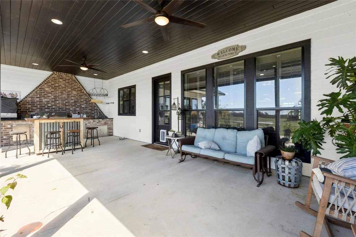 1170 Watterson Road Red Rock, TX 78662 - Photo 31 of 36 a living room with furniture large window and potted plants