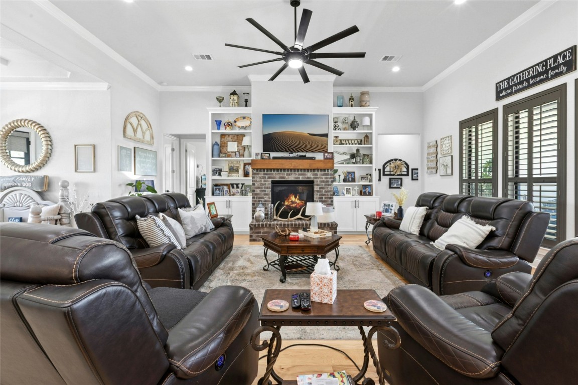 1170 Watterson Road Red Rock, TX 78662 - Photo 8 of 36 a living room with furniture a fireplace and a flat screen tv