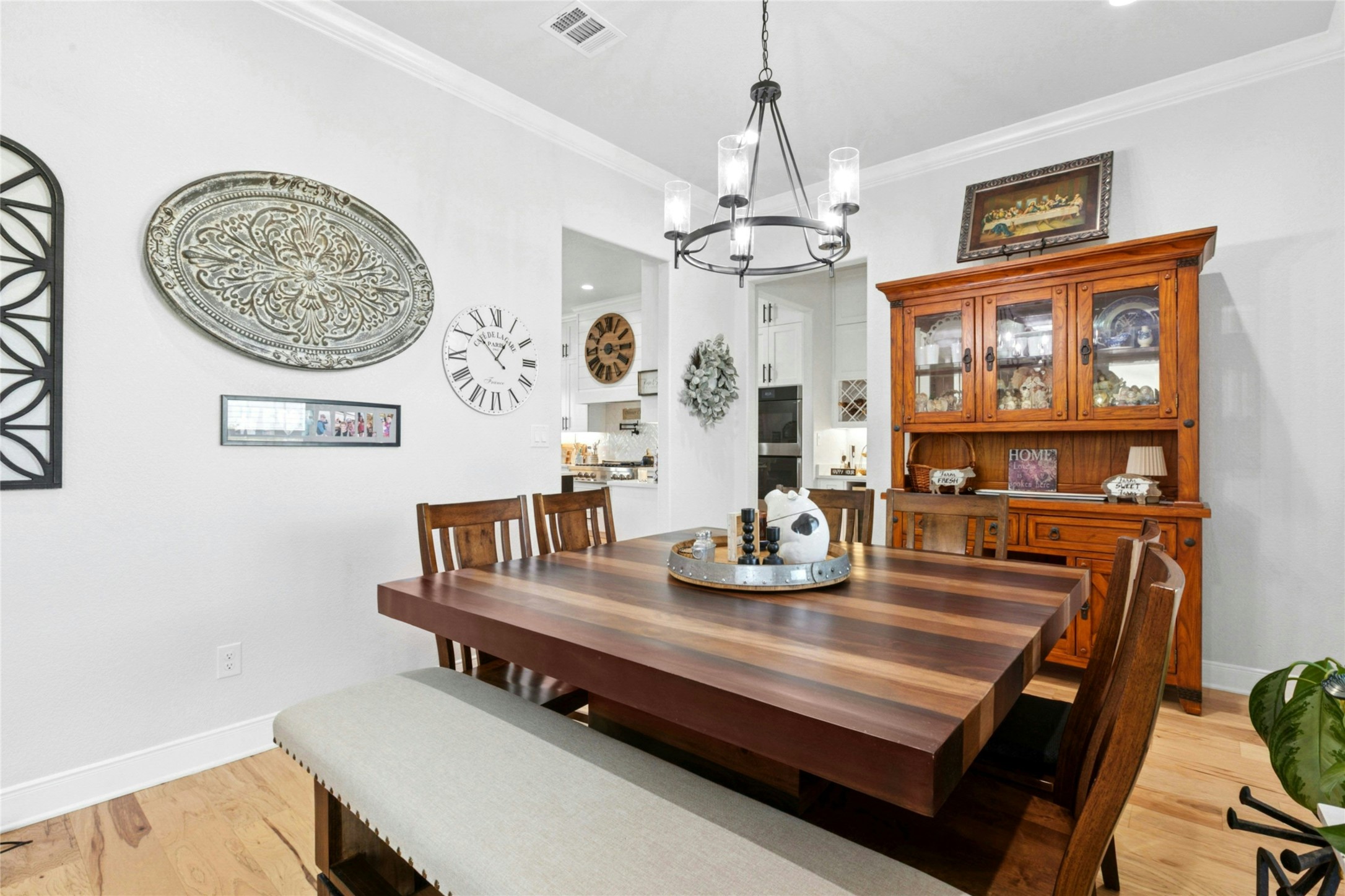 1170 Watterson Road Red Rock, TX 78662 - Photo 9 of 36 a view of a dining room with furniture a chandelier and wooden floor