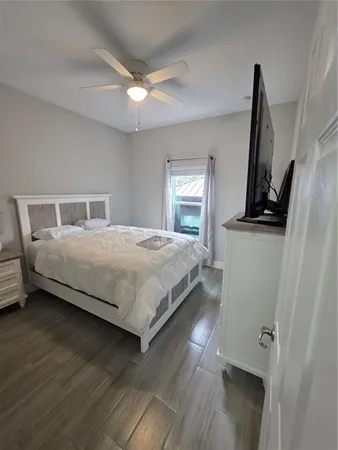 a bedroom with a bed and a flat screen tv