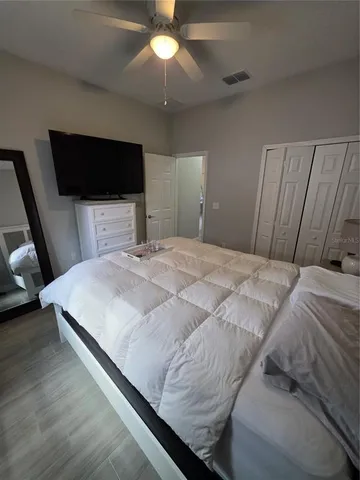 a bedroom with a bed and a chandelier