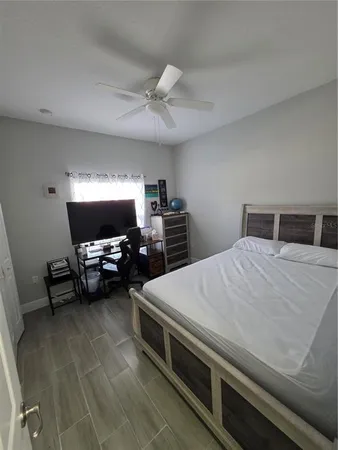 a bedroom with a bed and a chair