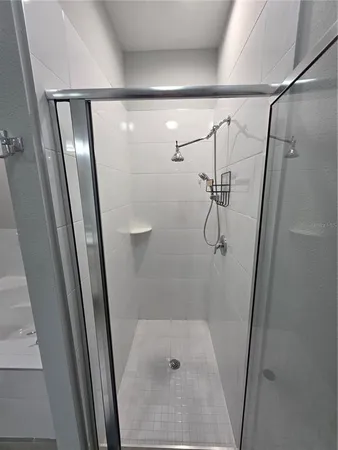 a bathroom with a granite countertop sink a toilet a mirror and shower curtain