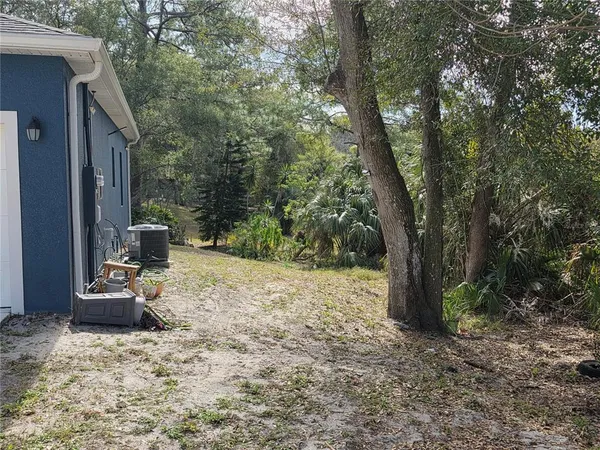 a kitchen with stainless steel appliances granite countertop a sink a stove a refrigerator cabinets and chairs