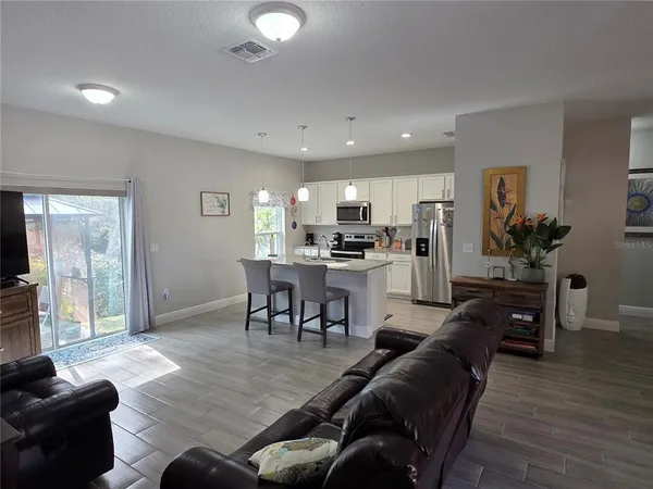 a view of a dining room with furniture and chandelier
