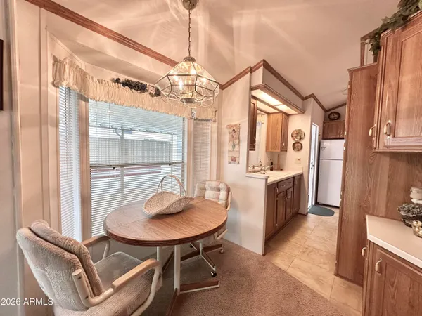 a dining room with furniture a chandelier and window