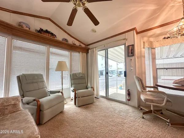 a living room with furniture and a floor to ceiling window