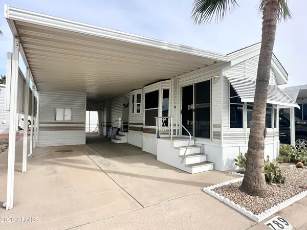 a view of a house with backyard and porch