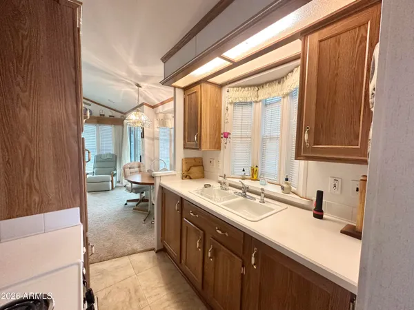a spacious bathroom with a double vanity sink a mirror and a bathtub