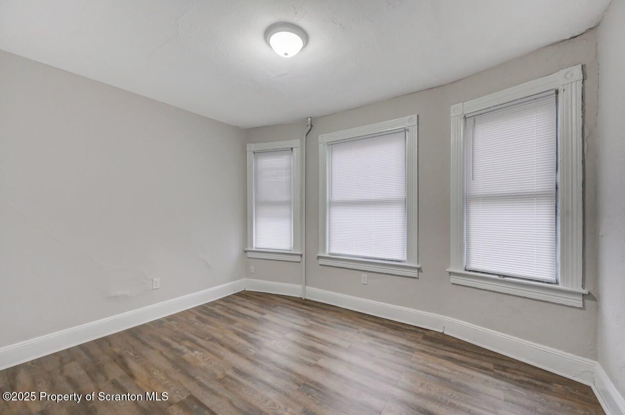 516 Harrison Avenue Scranton, PA 18510 - Photo 11 of 74 an empty room with wooden floor and windows