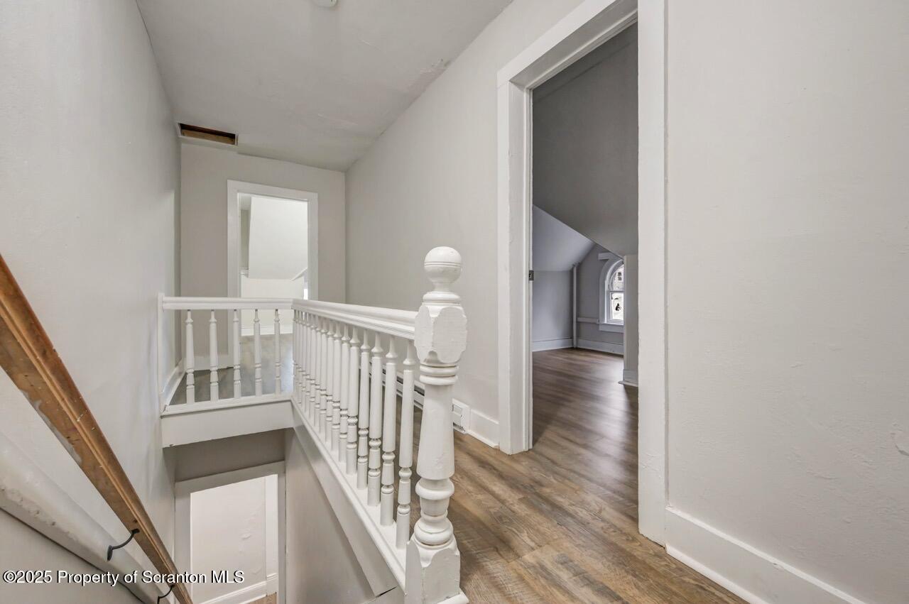 516 Harrison Avenue Scranton, PA 18510 - Photo 18 of 74 a view of a hallway with wooden floor and stairs