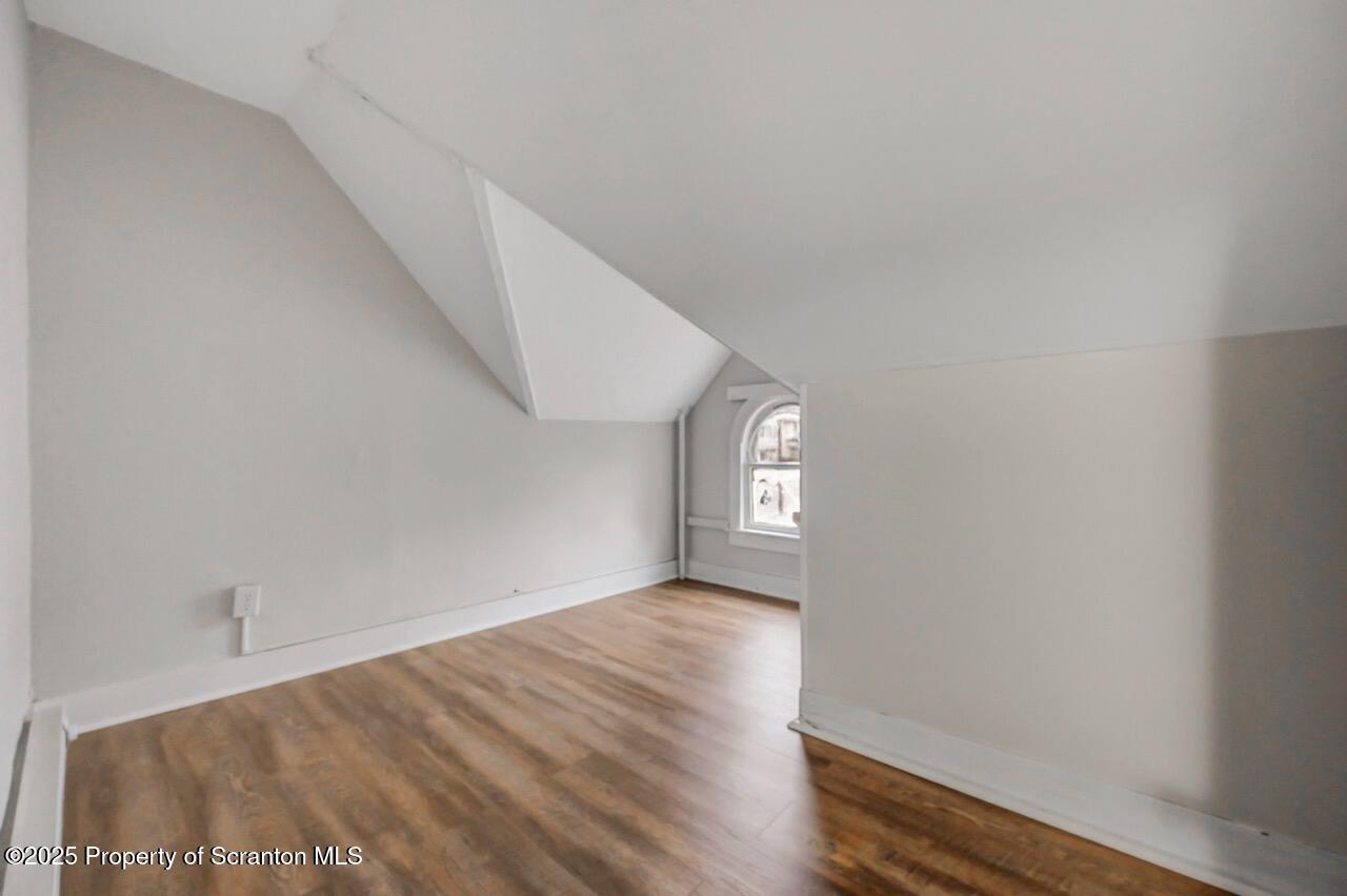 516 Harrison Avenue Scranton, PA 18510 - Photo 22 of 74 a view of an empty room with wooden floor and a window