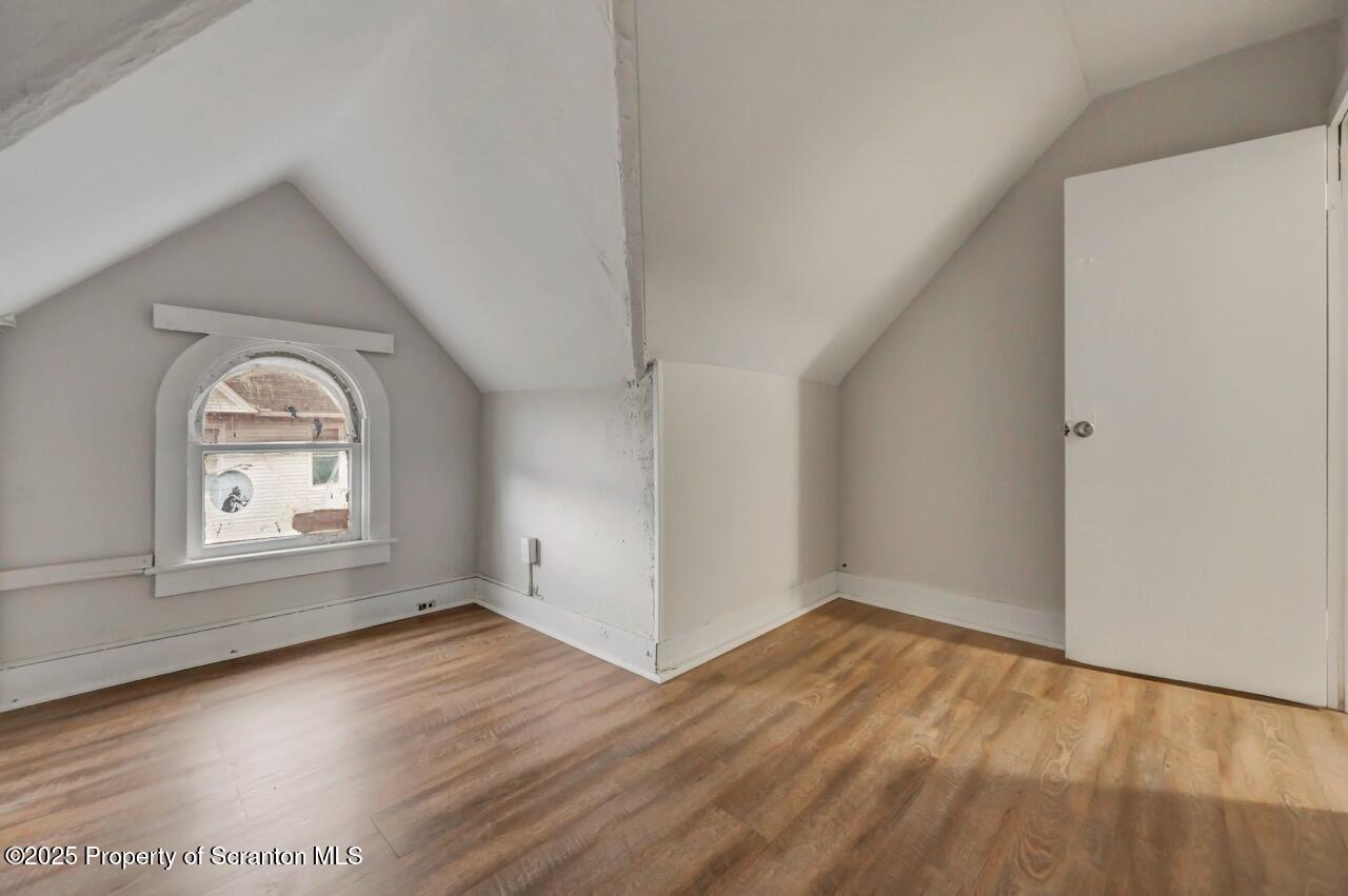 516 Harrison Avenue Scranton, PA 18510 - Photo 23 of 74 an empty room with wooden floor and windows