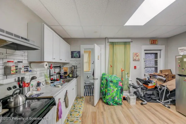 a living room with lots of furniture and a book shelf