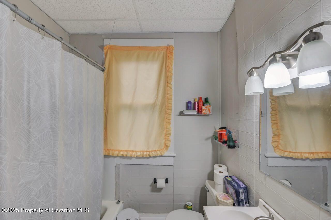516 Harrison Avenue Scranton, PA 18510 - Photo 34 of 74 a bathroom with a sink mirror and a window