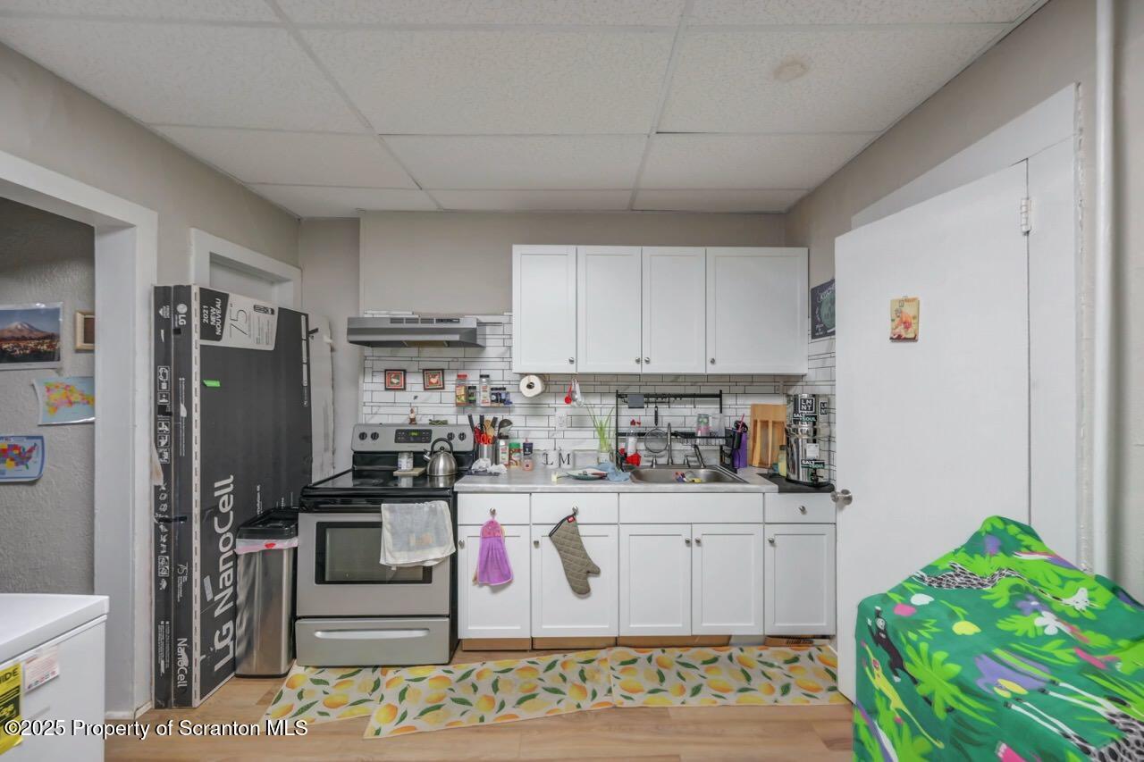 516 Harrison Avenue Scranton, PA 18510 - Photo 36 of 74 a kitchen with stainless steel appliances granite countertop a refrigerator sink and stove