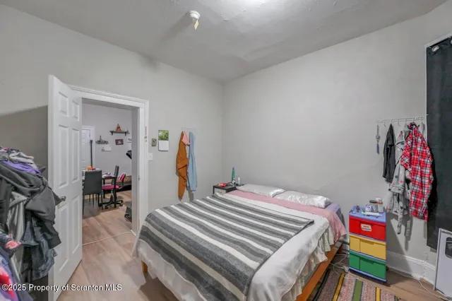 a bedroom with a bed and a lamp next to a window