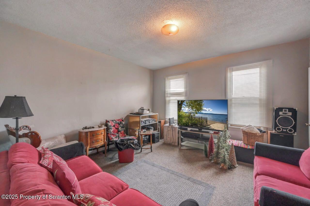 516 Harrison Avenue Scranton, PA 18510 - Photo 40 of 74 a living room with furniture and a flat screen tv