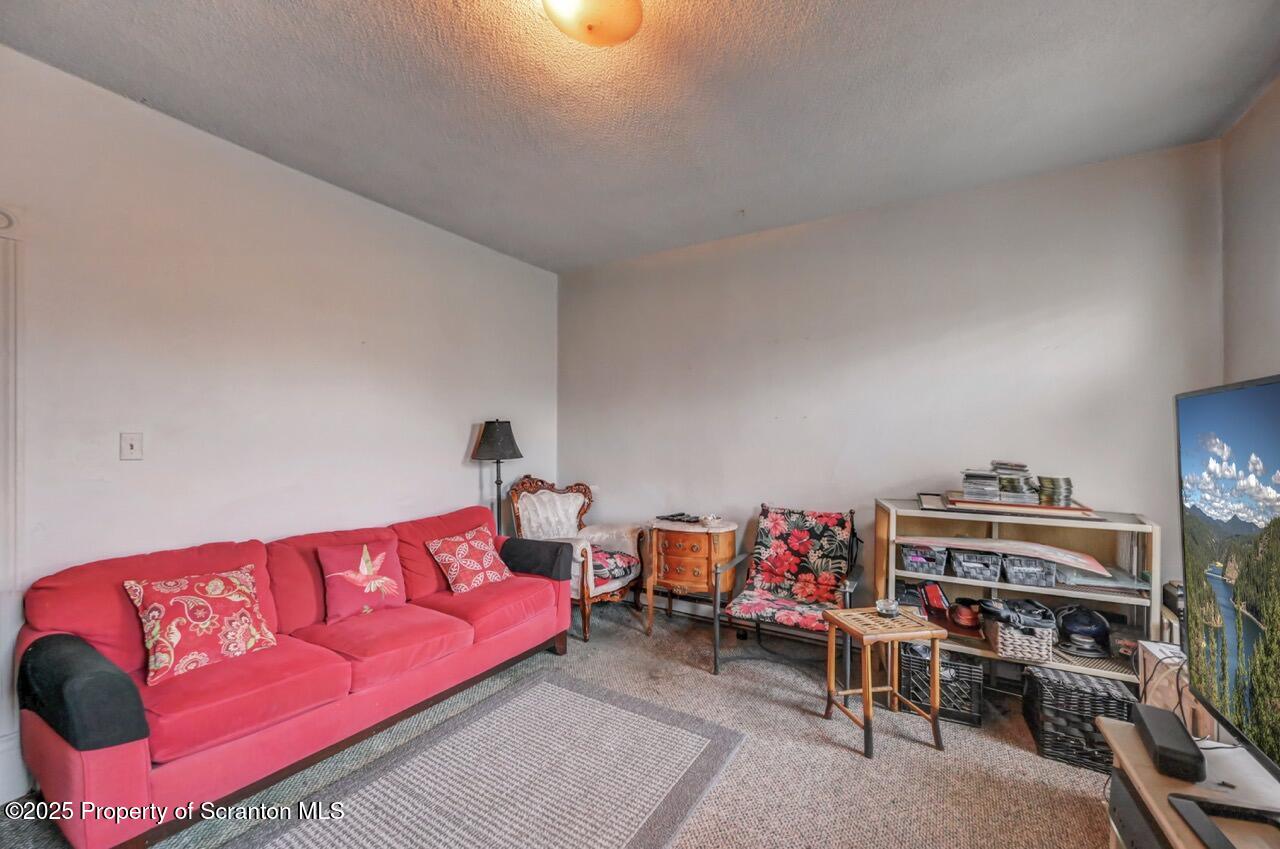 516 Harrison Avenue Scranton, PA 18510 - Photo 42 of 74 a living room with lots of furniture and a book shelf