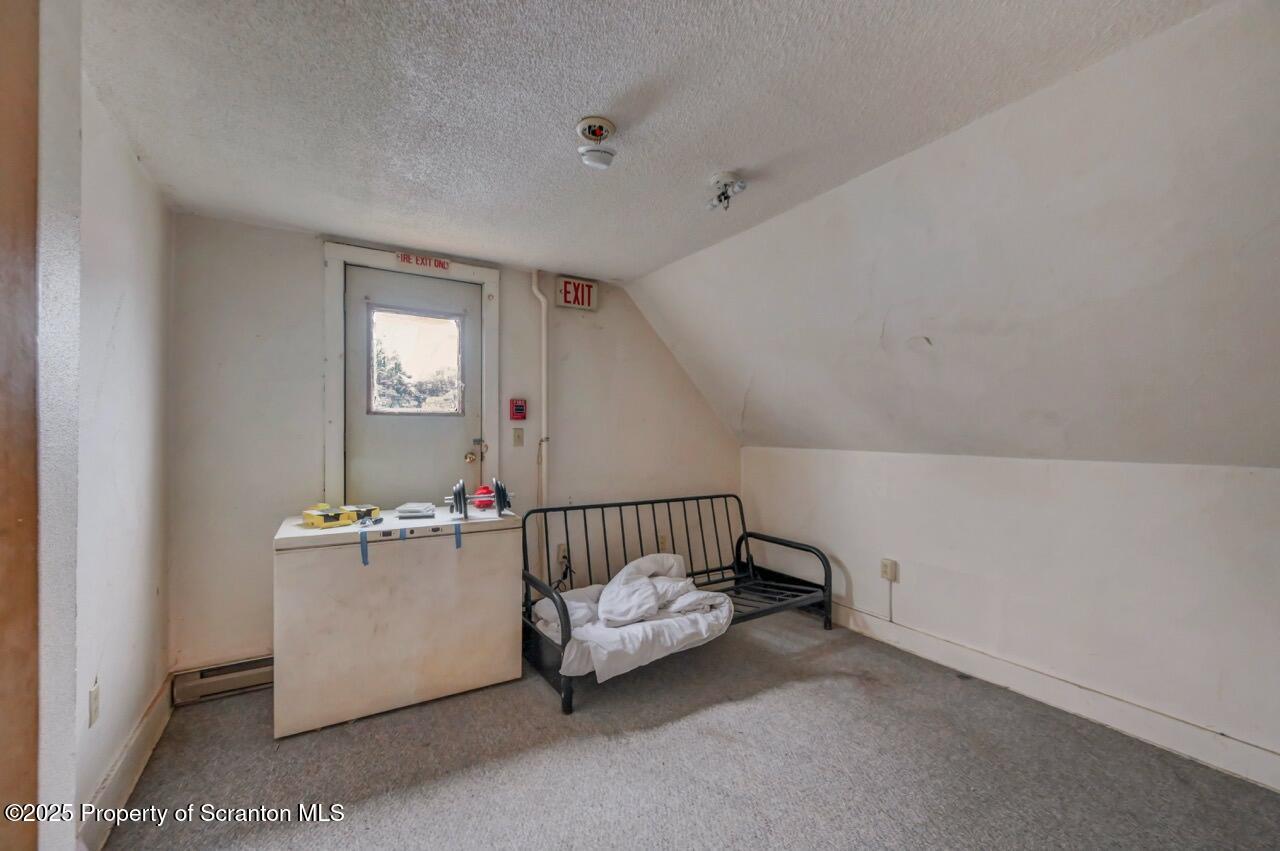 516 Harrison Avenue Scranton, PA 18510 - Photo 53 of 74 a view of a room with a baby crib wooden floor and windows