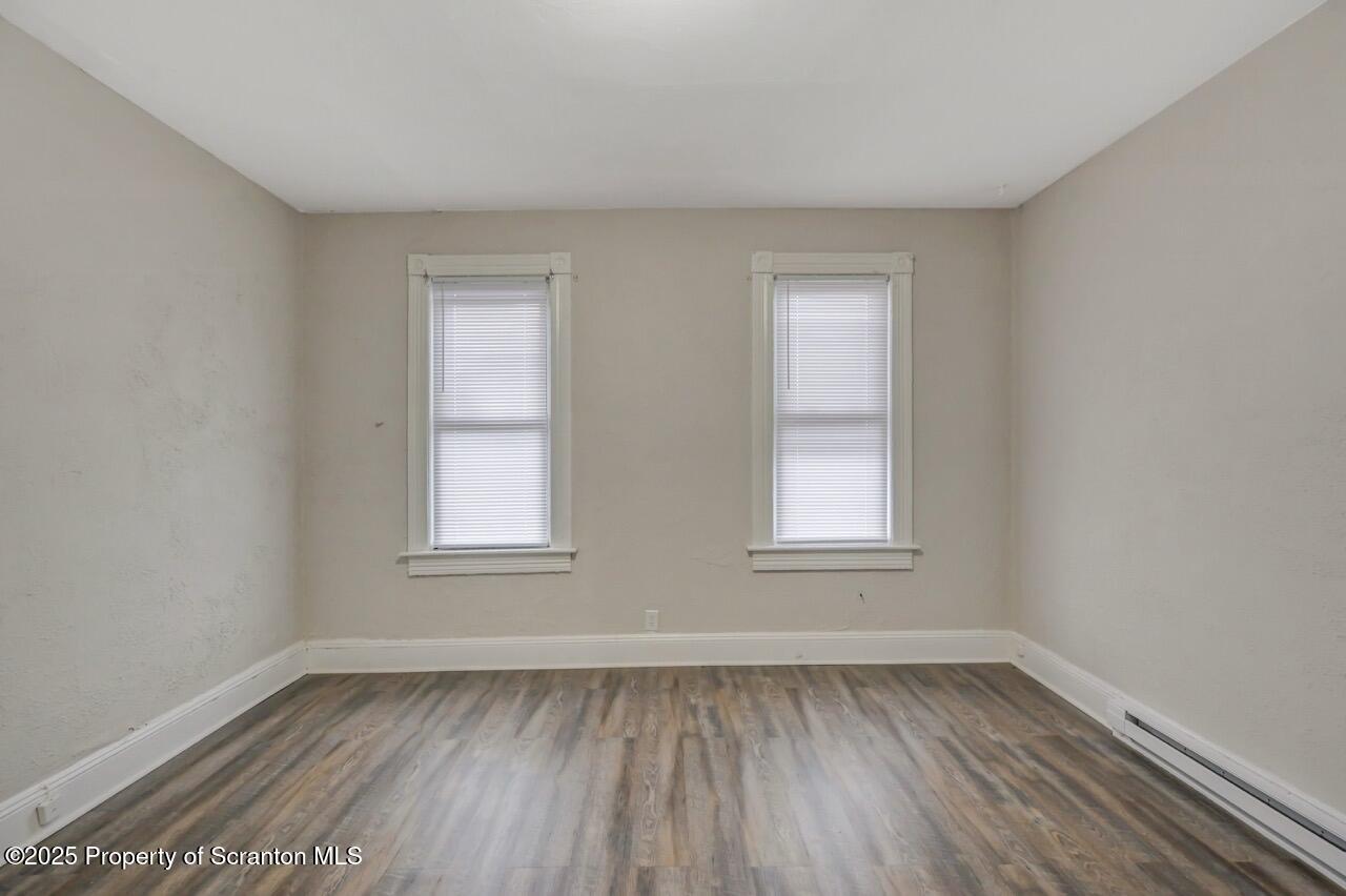 516 Harrison Avenue Scranton, PA 18510 - Photo 6 of 74 an empty room with wooden floor and windows